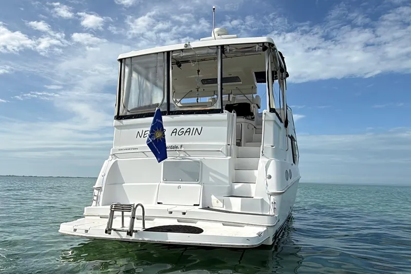  Yacht Photos Pics 1998 Silverton 40 Convertible yacht on calm sea under blue sky.