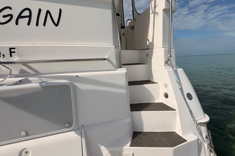 Yacht Photos Pics 1998 Silverton 40 Convertible yacht stairs with ocean view and clear sky.