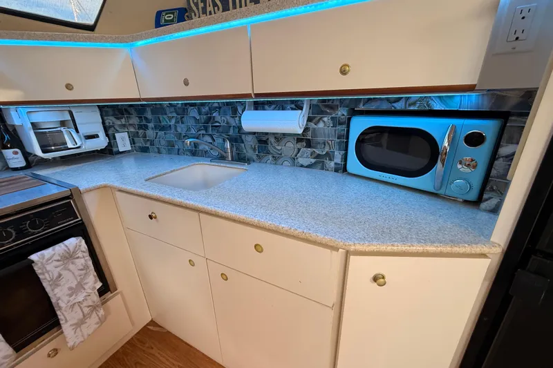  Yacht Photos Pics 1998 Silverton 40 Convertible kitchen with modern appliances and blue LED lighting.