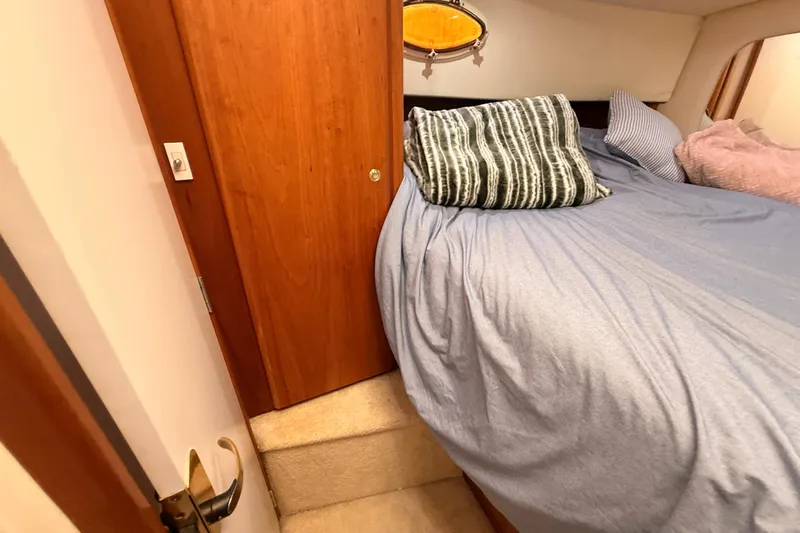  Yacht Photos Pics Cozy bedroom interior of 1998 Silverton 40 Convertible yacht with plush bedding.