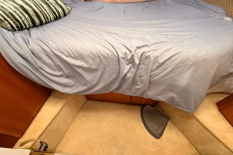  Yacht Photos Pics Interior cabin of 1998 Silverton 40 Convertible with bed and carpeted floor.