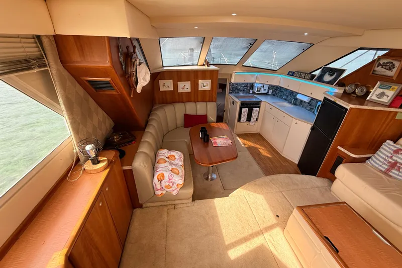  Yacht Photos Pics Luxurious interior of a 1998 Silverton 40 Convertible yacht with cozy seating and modern kitchen.