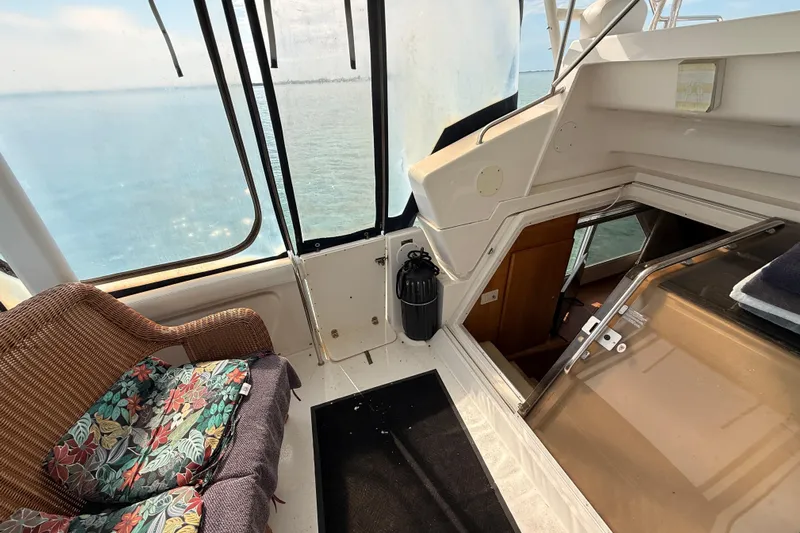  Yacht Photos Pics 1998 Silverton 40 Convertible yacht interior with wicker seating and ocean view.