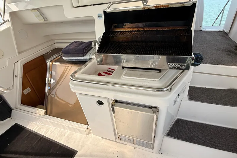  Yacht Photos Pics 1998 Silverton 40 Convertible yacht with built-in grill and storage area.