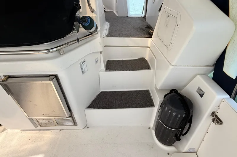  Yacht Photos Pics Interior steps of a 1998 Silverton 40 Convertible yacht with carpeted stairs and stainless steel railing.