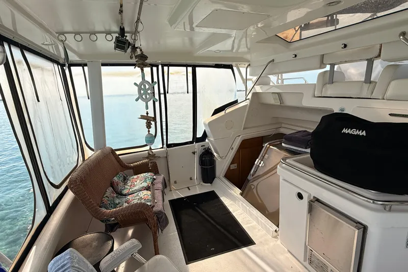  Yacht Photos Pics Interior of a 1998 Silverton 40 Convertible yacht with wicker seating and ocean view.