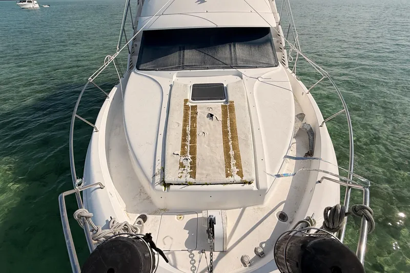  Yacht Photos Pics 1998 Silverton 40 Convertible yacht on clear water, viewed from the bow.