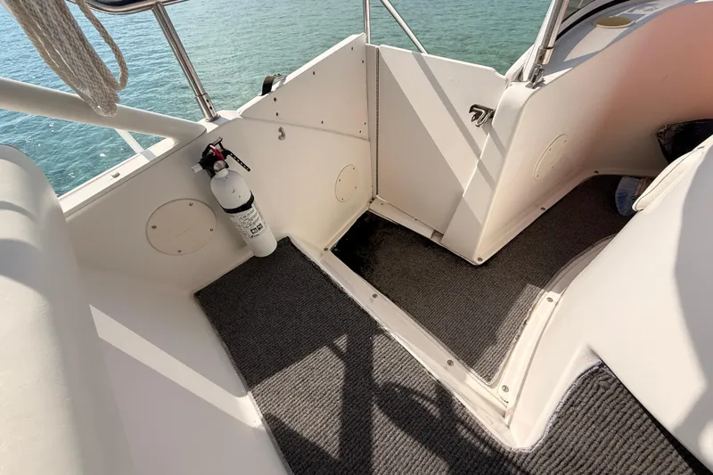  Yacht Photos Pics 1998 Silverton 40 Convertible boat interior with fire extinguisher and carpeted flooring.