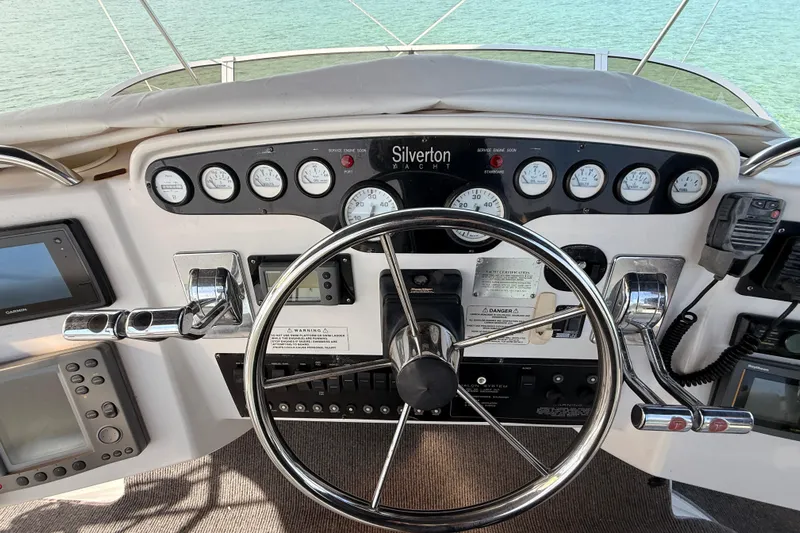  Yacht Photos Pics 1998 Silverton 40 Convertible yacht helm with steering wheel and control panel.