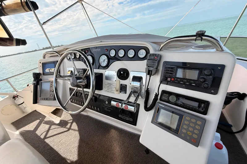  Yacht Photos Pics 1998 Silverton 40 Convertible yacht helm with steering wheel and navigation instruments.