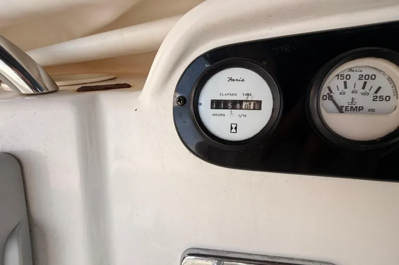  Yacht Photos Pics Instrument panel of a 1998 Silverton 40 Convertible boat showing elapsed time and temperature gauges.