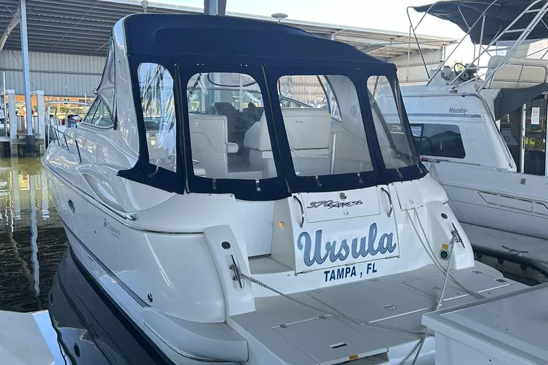 Ursula Yacht Photos Pics 2006 Cruisers Yachts 370 Express docked, featuring a blue canopy and "Ursula" nameplate.