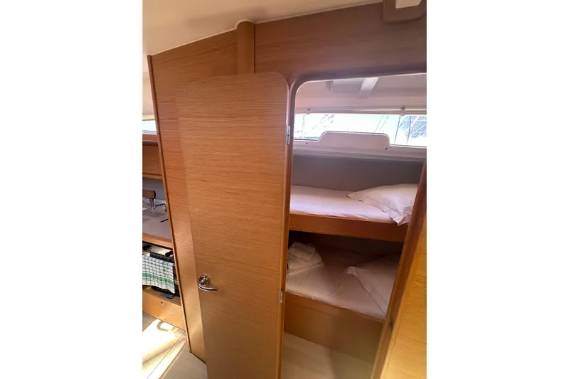  Yacht Photos Pics Interior of 2020 Dufour 430 yacht showing cozy bunk beds and wooden finish.