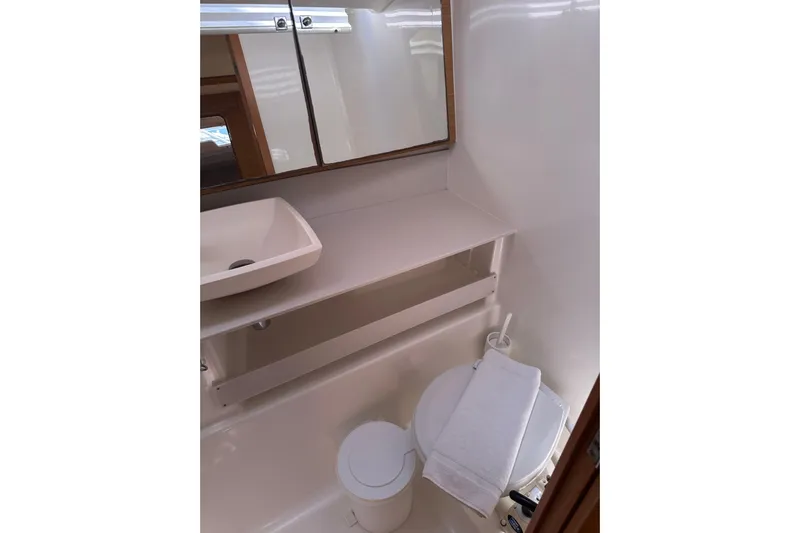  Yacht Photos Pics Bathroom interior of 2020 Dufour 430 yacht with sink, mirror, and toilet.