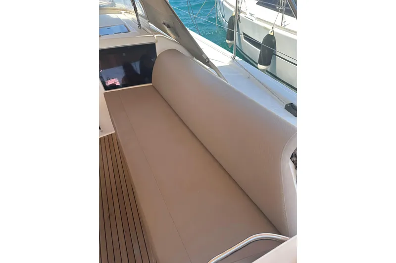  Yacht Photos Pics 2020 Dufour 430 yacht with beige seating and teak deck, docked by the water.