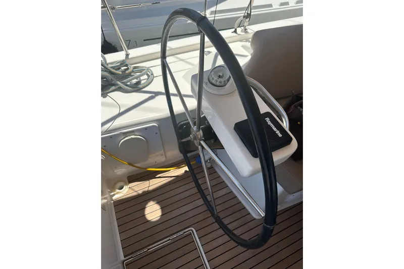  Yacht Photos Pics Steering wheel of 2020 Dufour 430 sailboat with compass and navigation equipment.