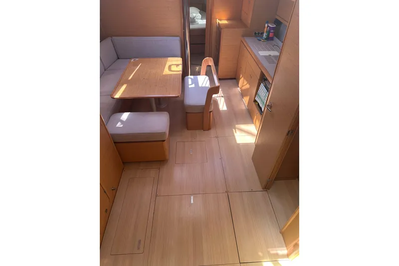 Yacht Photos Pics 2020 Dufour 430 yacht interior with dining area and kitchen, featuring light wood finishes.