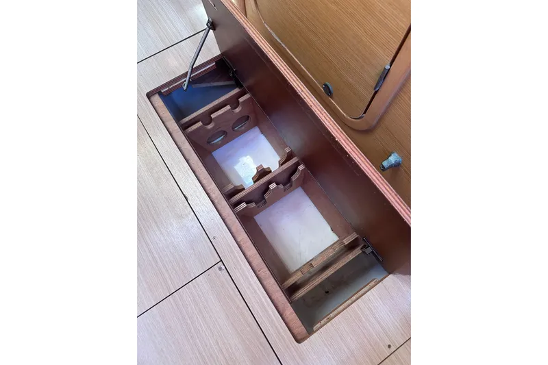  Yacht Photos Pics Dufour 430 (2020) yacht interior storage compartment with wooden finish.