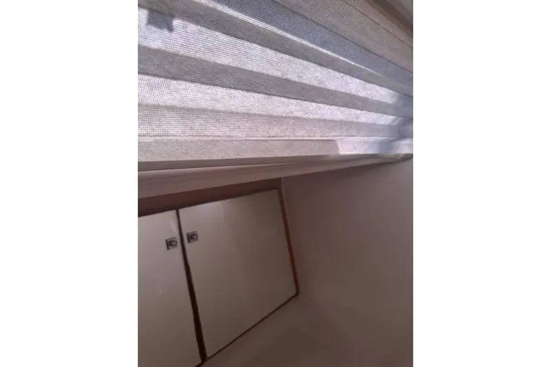  Yacht Photos Pics Interior view of a 2020 Dufour 430 yacht, featuring window blinds and storage cabinets.