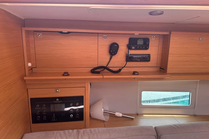  Yacht Photos Pics Interior of a 2020 Dufour 430 yacht with wooden cabinetry and navigation equipment.