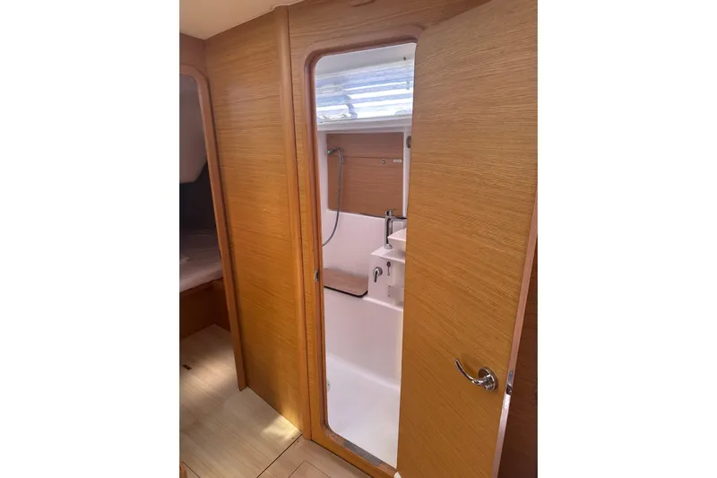  Yacht Photos Pics Interior of 2020 Dufour 430 yacht showing bathroom with wooden door and shower.
