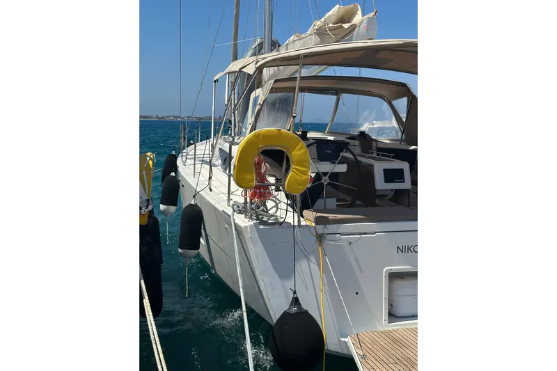 Yacht Photos Pics 2020 Dufour 430 sailboat with yellow life ring, docked in clear blue waters.
