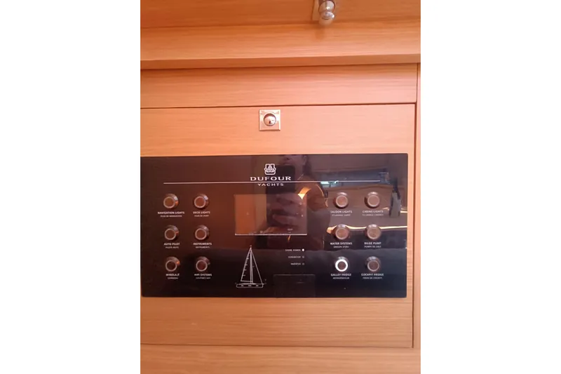  Yacht Photos Pics Control panel of a 2020 Dufour 430 yacht with various switches and display.