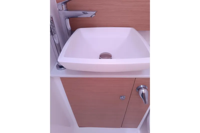  Yacht Photos Pics Modern bathroom sink on 2020 Dufour 430 yacht, featuring sleek design and wood accents.