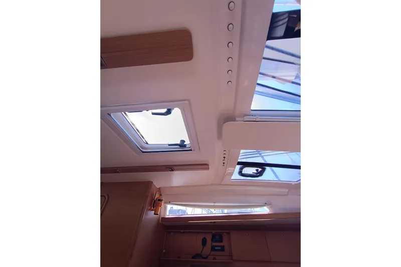  Yacht Photos Pics Interior view of 2020 Dufour 430 yacht, featuring skylights and wooden cabinetry.