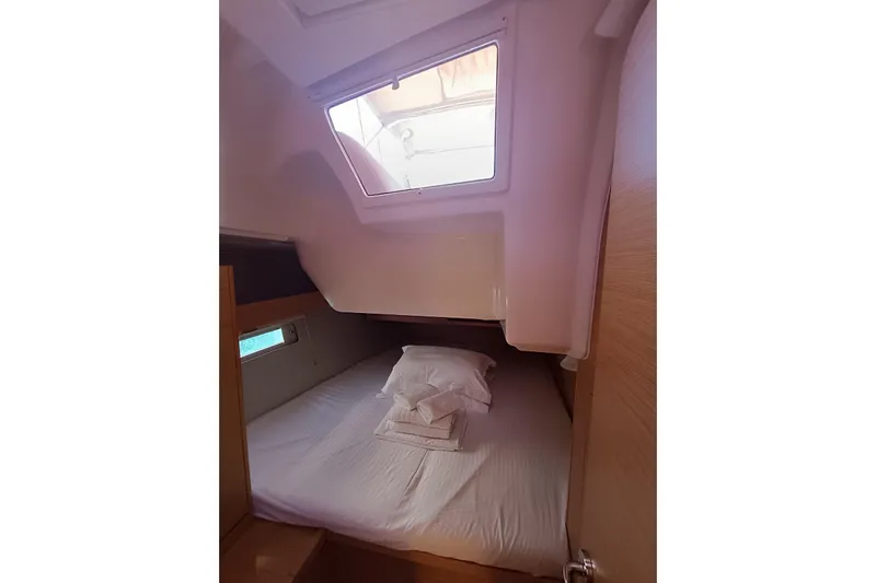  Yacht Photos Pics Cozy cabin interior of 2020 Dufour 430 yacht with bed and window.