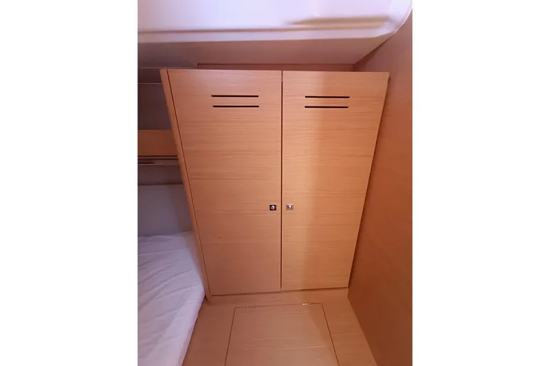  Yacht Photos Pics Wooden cabin interior of 2020 Dufour 430 yacht, featuring a sleek wardrobe design.