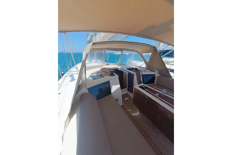 Yacht Photos Pics 2020 Dufour 430 yacht interior with seating, table, and ocean view.