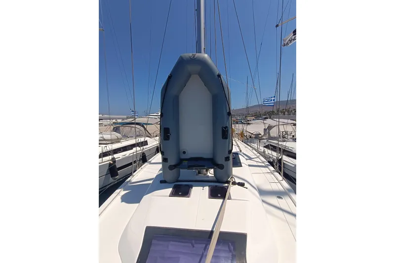 Yacht Photos Pics Dufour 430 sailboat deck with inflatable dinghy, 2020 model, docked in a marina.