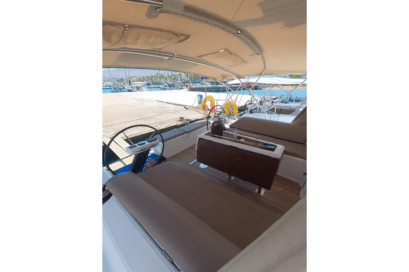  Yacht Photos Pics 2020 Dufour 430 yacht cockpit with seating and steering wheel, docked at marina.