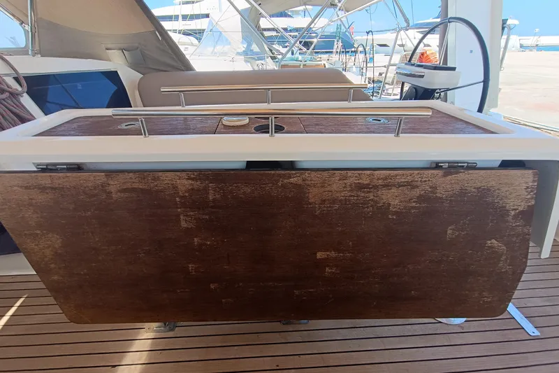  Yacht Photos Pics Dufour 430 yacht cockpit table, 2020 model, with wooden finish and stainless steel accents.