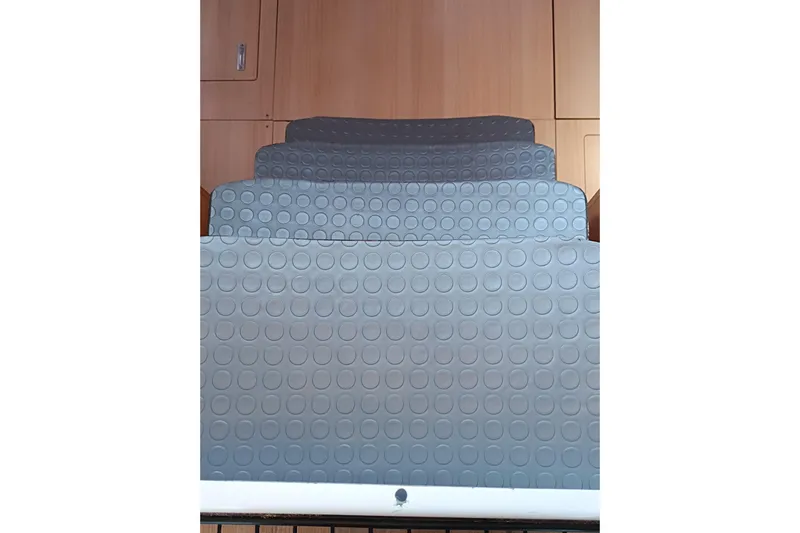  Yacht Photos Pics Gray non-slip steps inside a 2020 Dufour 430 yacht, featuring circular patterns.