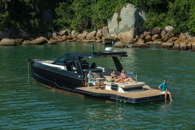  Yacht Photos Pics 2026 Schaefer V44 yacht with people relaxing on deck in scenic waters.