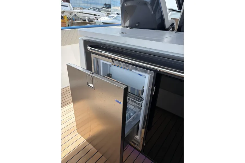  Yacht Photos Pics Open stainless steel refrigerator on Schaefer V44 yacht, 2026 model, with wooden deck.