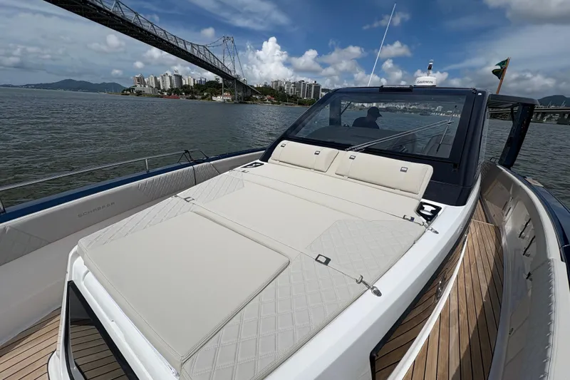  Yacht Photos Pics 2026 Schaefer V44 yacht with spacious deck, cruising under a bridge on a sunny day.