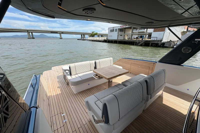  Yacht Photos Pics Luxurious 2026 Schaefer V44 yacht deck with elegant seating and scenic waterfront view.
