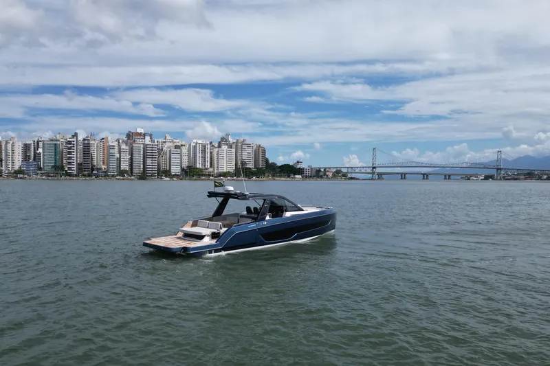  Yacht Photos Pics 2026 Schaefer V44 yacht cruising near city skyline and bridge.