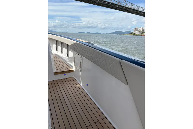  Yacht Photos Pics Schaefer V44 yacht deck with wooden flooring, ocean view, and bridge in the background, 2026 model.