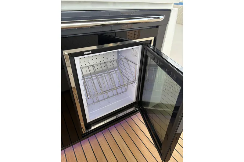  Yacht Photos Pics Open Schaefer V44 refrigerator on yacht, showcasing interior storage racks, 2026 model.
