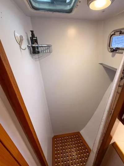 Argonaut Yacht Photos Pics Compact shower area in 1984 Wilbur 38 boat with wooden floor and skylight.