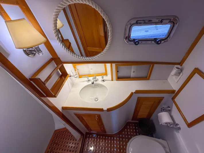 Argonaut Yacht Photos Pics Luxurious 1984 Wilbur 38 yacht bathroom with wooden accents and nautical decor.