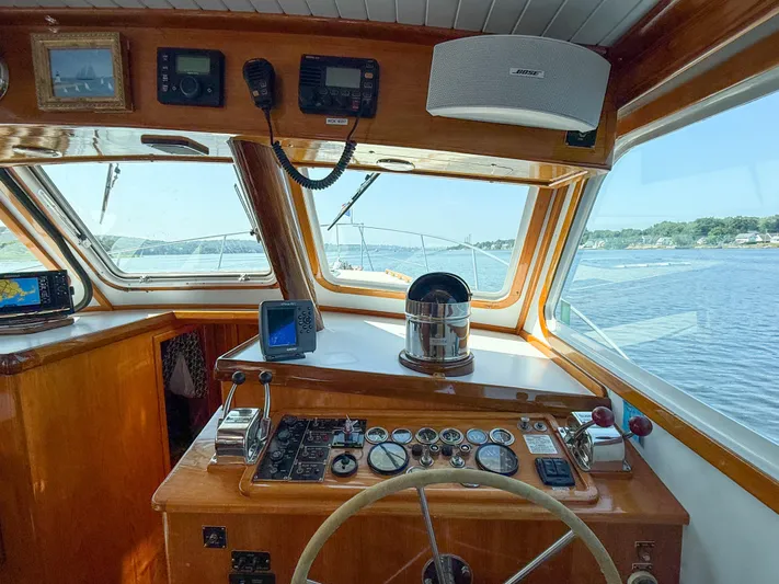 Argonaut Yacht Photos Pics Helm of 1984 Wilbur 38 boat with navigation instruments and scenic water view.