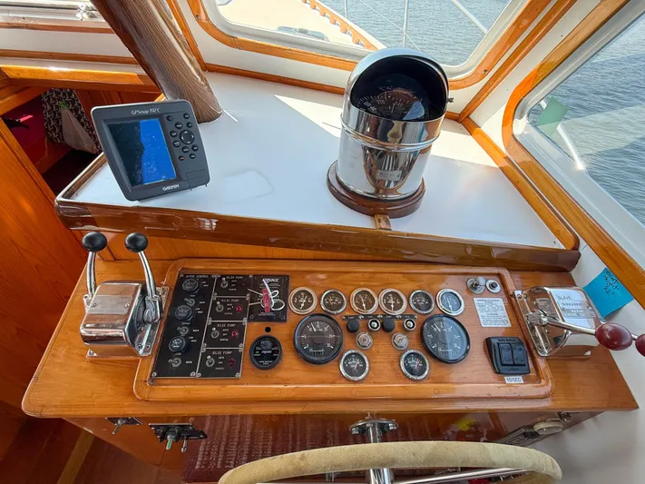 Argonaut Yacht Photos Pics Control panel of a 1984 Wilbur 38 boat with gauges and navigation equipment.