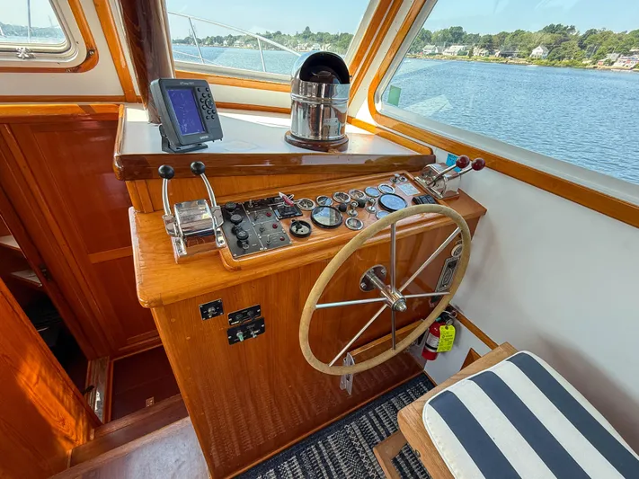 Argonaut Yacht Photos Pics Helm of 1984 Wilbur 38 boat with steering wheel, gauges, and navigation equipment.