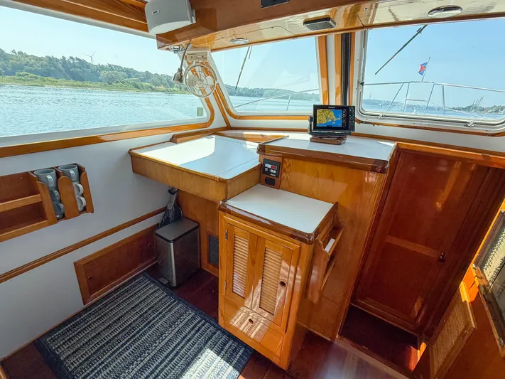 Argonaut Yacht Photos Pics Interior of 1984 Wilbur 38 boat with wooden cabinetry and navigation equipment.