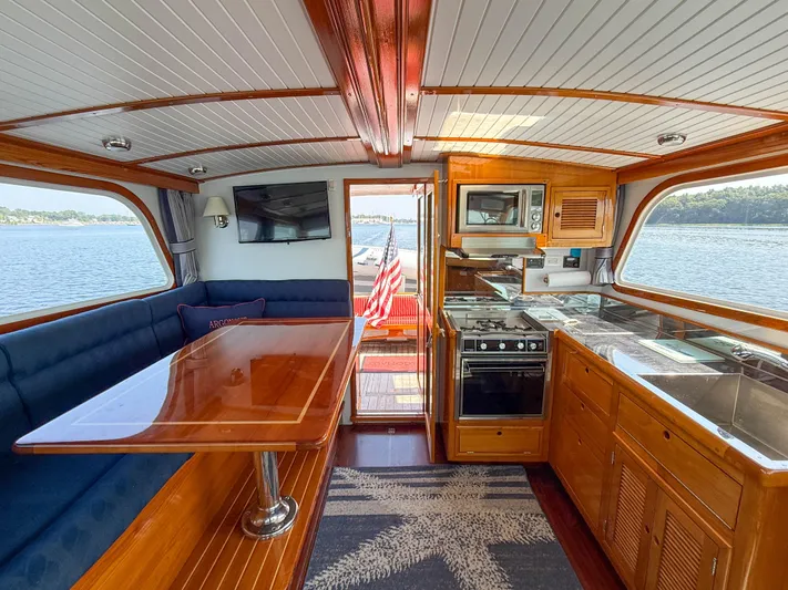 Argonaut Yacht Photos Pics Interior of 1984 Wilbur 38 boat with kitchen, dining area, and scenic water view.